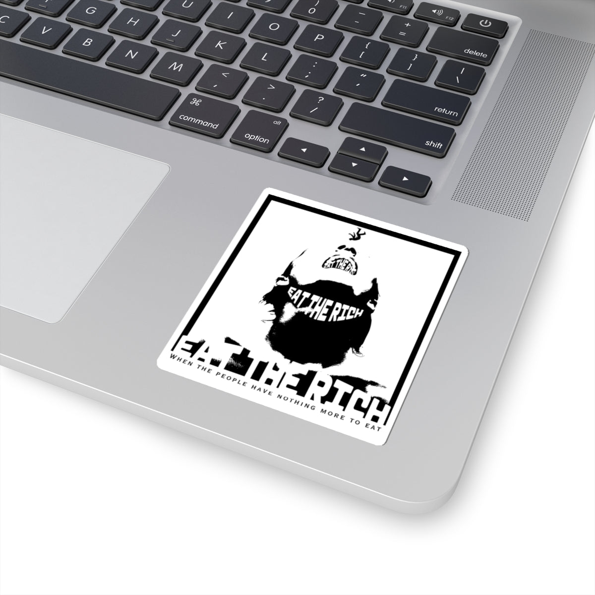 Close-up of Eat the Rich activist sticker showing durable vinyl material